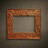 Rectangular masterwork frame hand-carved from solid Iroko hardwood. The design features high-relief Norse mythology motifs, including intertwining serpents with detailed scales and stylized predatory birds at the top corners. Intricate Scandinavian knotwork flows throughout the entire border. Hand-finished with natural oils to highlight the dense grain and rich amber luster of the Iroko wood. A museum-quality architectural piece for luxury mirrors or fine art.