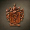 Custom hand-carved Iroko wood family crest for the name "Doyle". This bespoke heraldic wall plaque features a shield with three stag heads, a knight's helmet topped with a small deer figure, and ornate acanthus leaf mantling. Finished with natural wax to accentuate the high-quality wood grain. A premium example of custom-made family heraldry and personalized wooden legacy gifts.