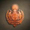 Custom hand-carved Iroko wood heraldic masterpiece. This intricate bespoke relief features two realistic elephants as shield supporters, a central oval emblem with a fern leaf and solar wheel, and a sunburst with a trident at the top. The design is framed by a lush laurel wreath and multiple scrolls with motivational mottos including "Love Forte" and "Viva Fuerte". Finished with natural wax to accentuate the complex textures. A premier example of luxury custom family crests and high-end wooden wall art.