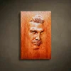 Custom hand-carved Iroko wood portrait relief. This personalized wood carving features a realistic male face with high-detail hair and mustache textures, finished with natural oil to highlight the grain. An example of a bespoke 3D wooden portrait from a photo, perfect for unique custom-made gifts and commemorative wall art.