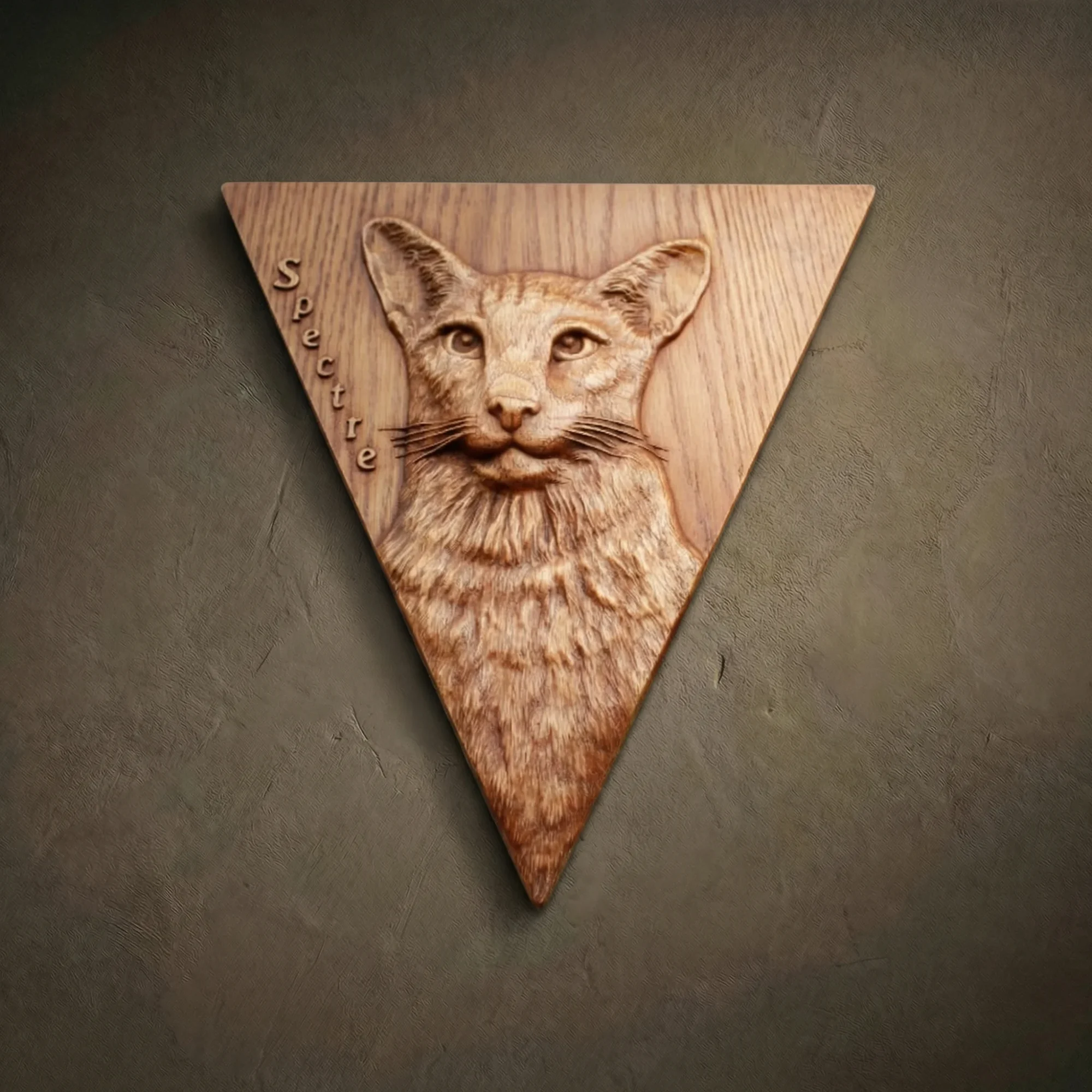 Custom hand-carved Iroko wood triangular relief portrait of a cat named "Spectre." This personalized pet memorial features realistic fur textures and whiskers, finished with natural oil to enhance the wood grain. A perfect example of a bespoke pet portrait carved from a photo and unique custom animal wall art.