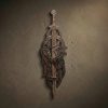 Hand-carved dark wood vertical sword display featuring intricate Viking Urnes style knotwork. Pierced carving design on solid hardwood with a deep espresso finish. Symmetrical interlaced patterns create a secure integrated mount for a single sword. Professional artisan woodwork with refined textures and historical Norse aesthetic.