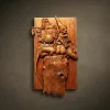 Vertical high-relief wall plaque titled "Gnome’s Secret Path" hand-carved from solid Iroko hardwood. The sculpture features a whimsical gnome in a pointed hat riding a large mouse over a tree stump. The mouse carries a detailed load of travel gear, including baskets, chests, and a lantern. Hand-finished with natural oils to highlight the rich, golden-brown grain of the Iroko wood. A charming piece of fairytale-themed wood art for luxury home nurseries or creative interior spaces.